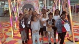 Boston fifth graders posing in the entryway at AIA25.